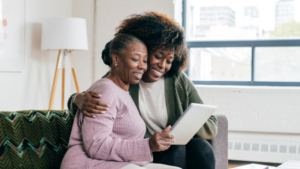 a senior lady reading with her daughter